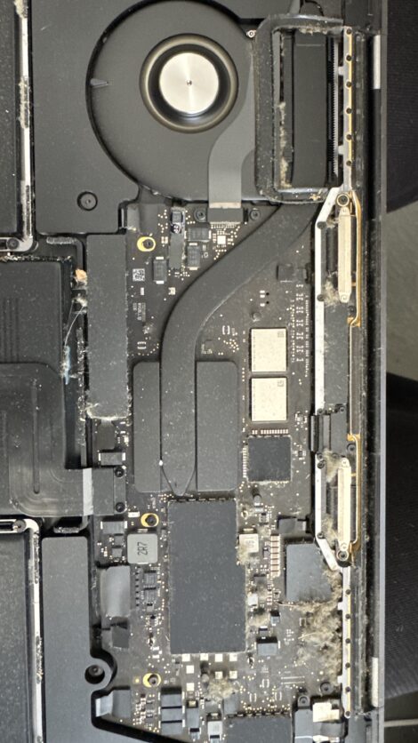 MacBook logic board and cooling fan during repair