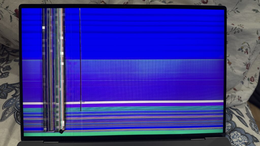 Laptop display with blue screen and vertical line fault