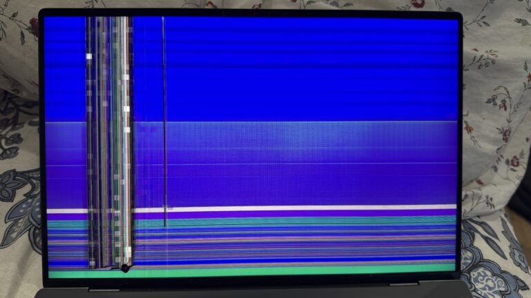 Laptop display with blue screen and vertical line fault