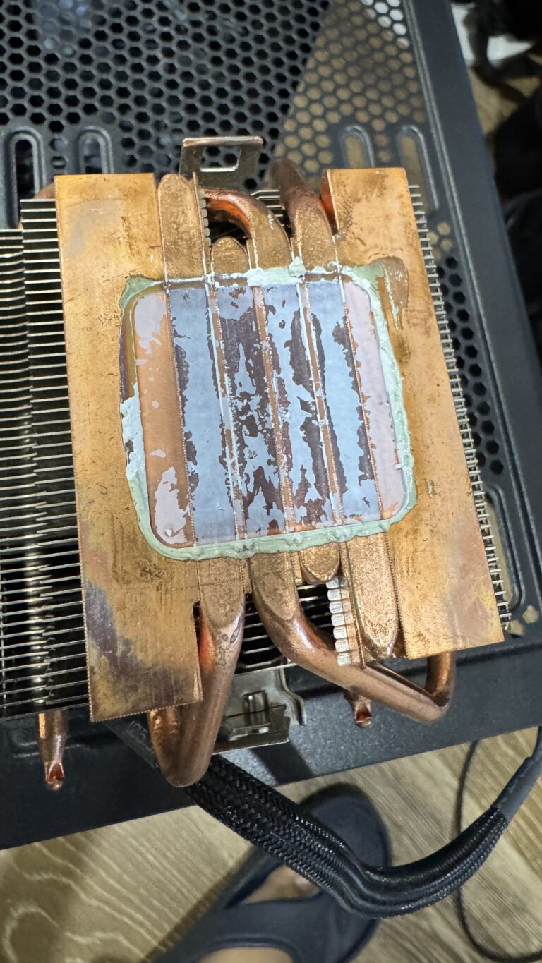 CPU cooler with old thermal paste removed from a desktop PC